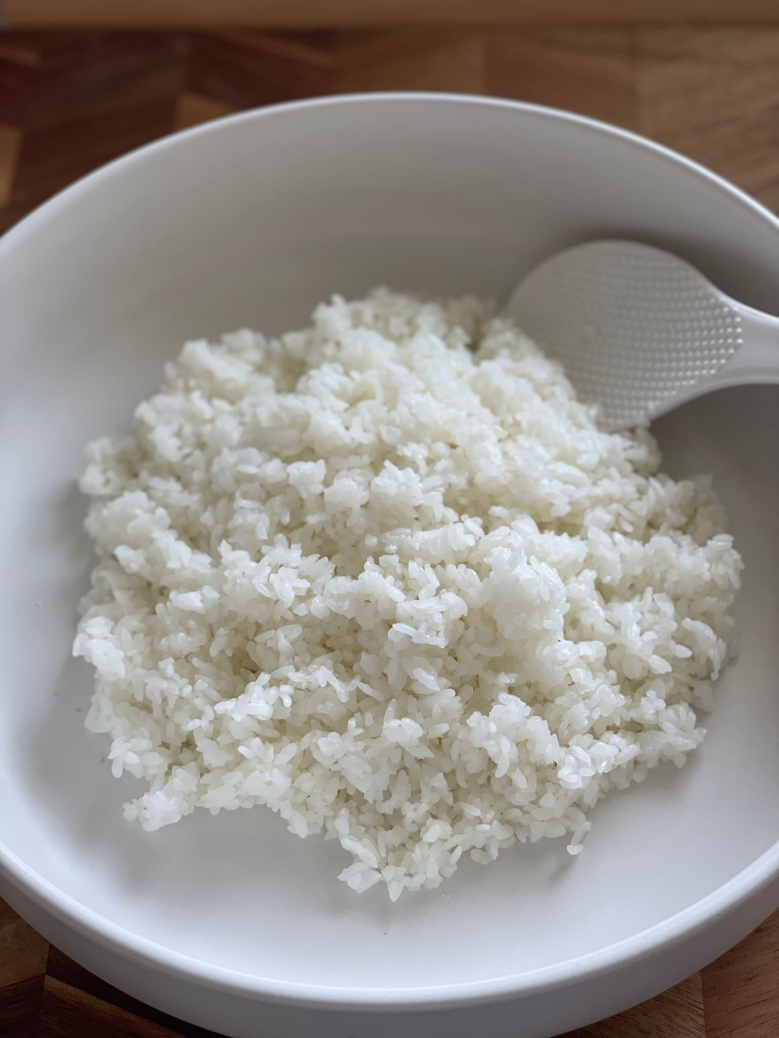 Prepared sushi rice in a wooden bowl