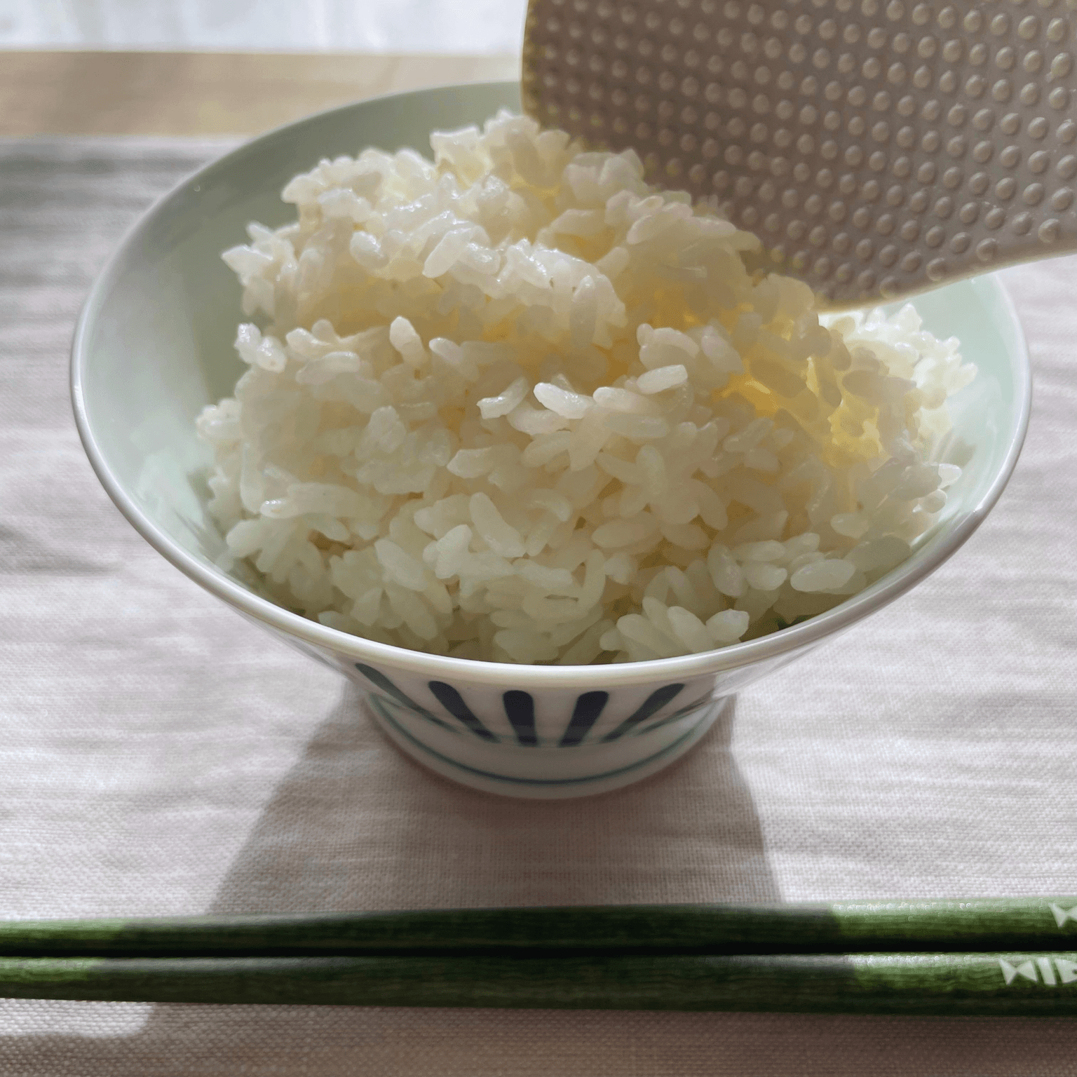 Cooked Japanese rice in a bowl with chopsticks