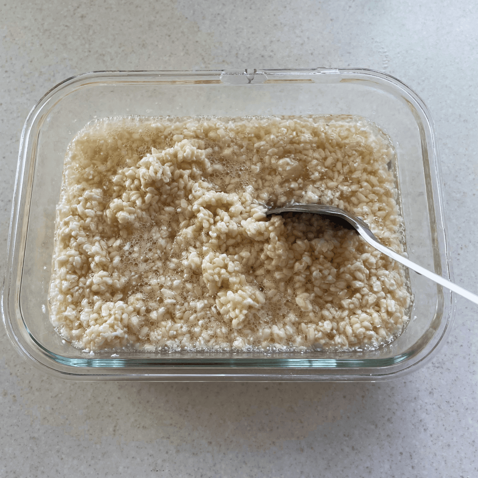 Dried rice koji being mixed into the salted water