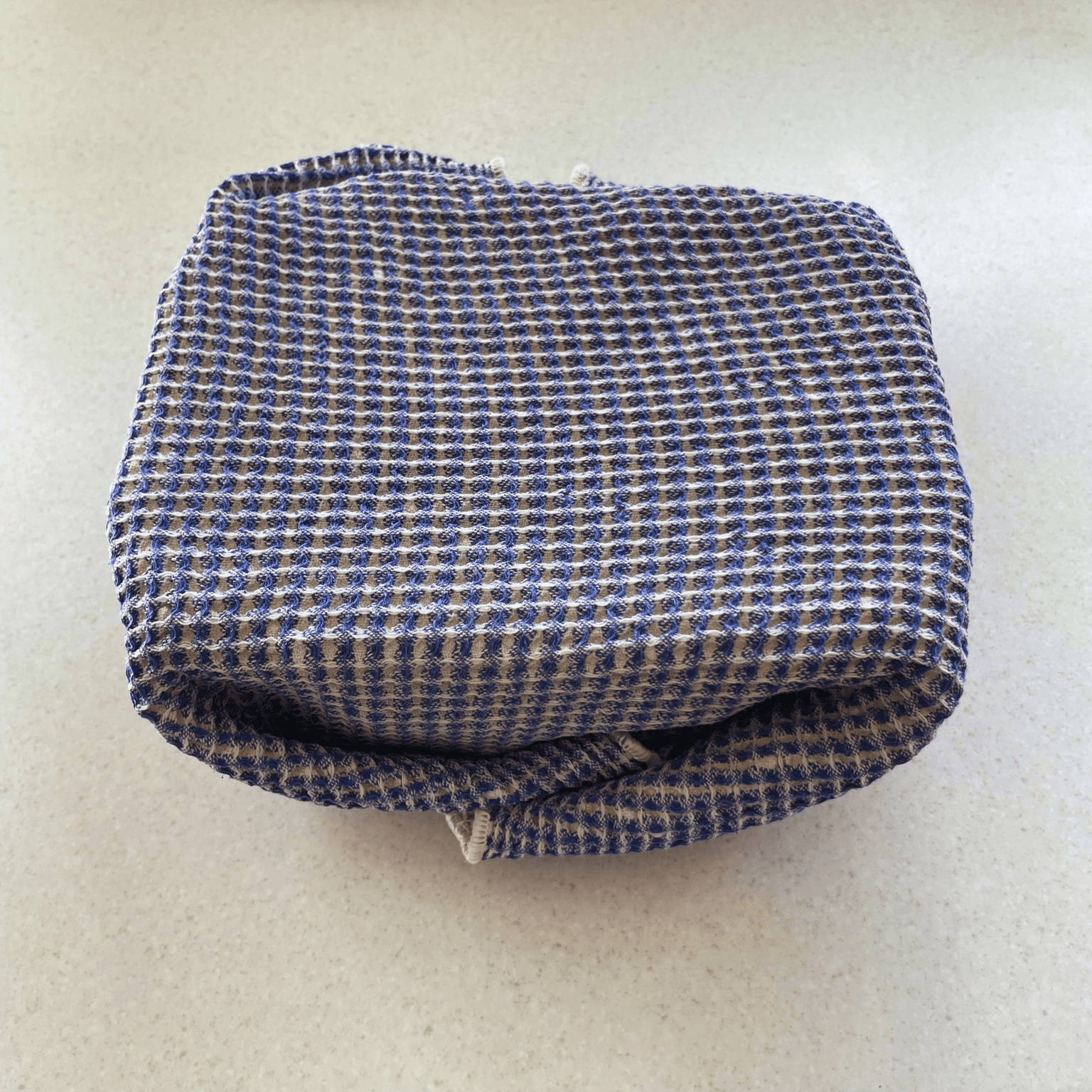 Shio koji container wrapped in a clean towel to keep it warm