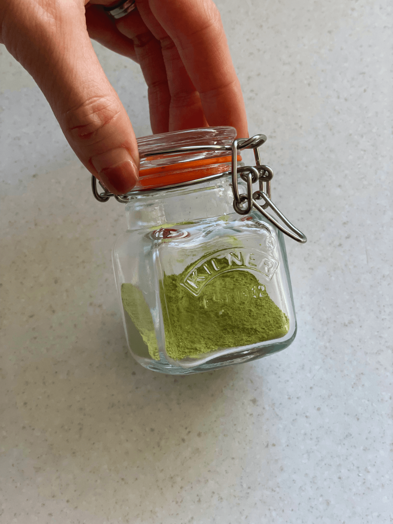 Matcha salt stored in a small jar