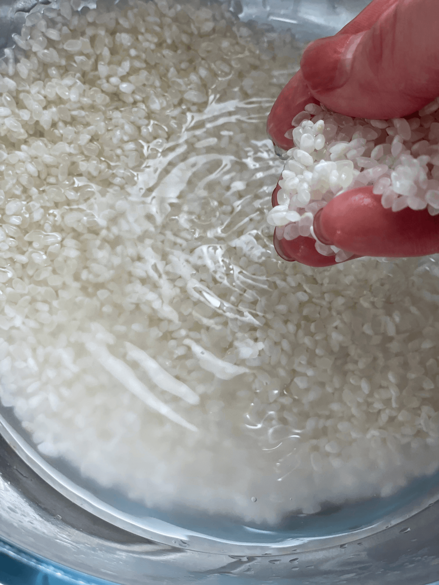Rinsing Japanese rice in a bowl