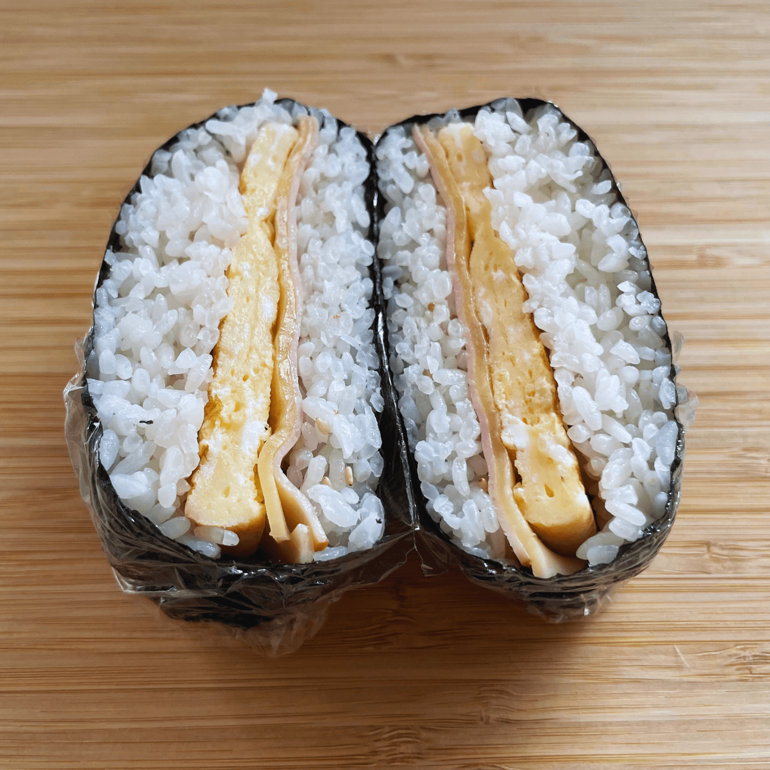 Ham, cheese and egg onigirazu cut in half