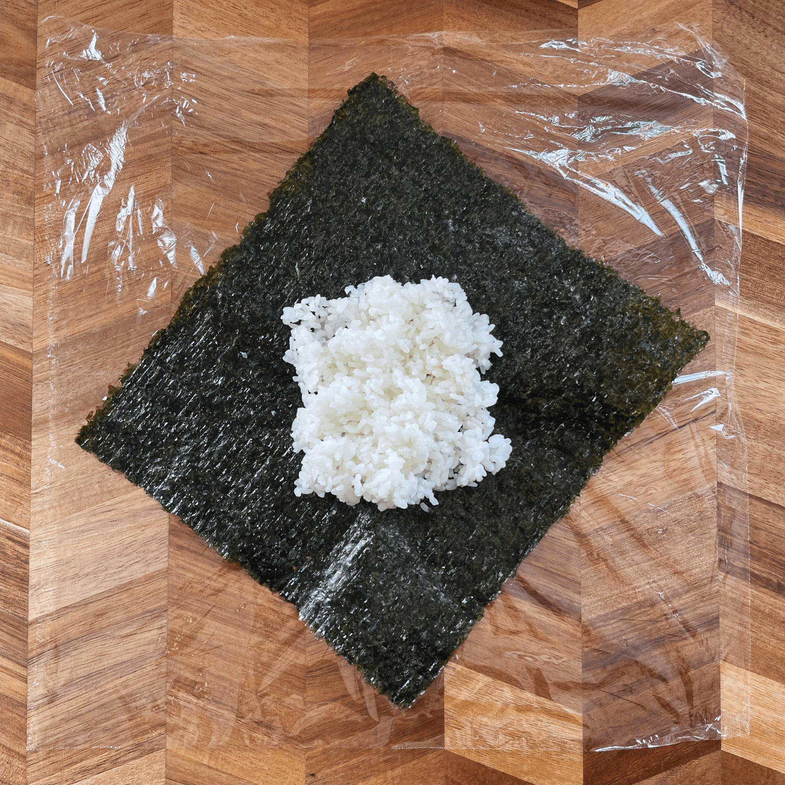 Rice placed on nori for onigirazu