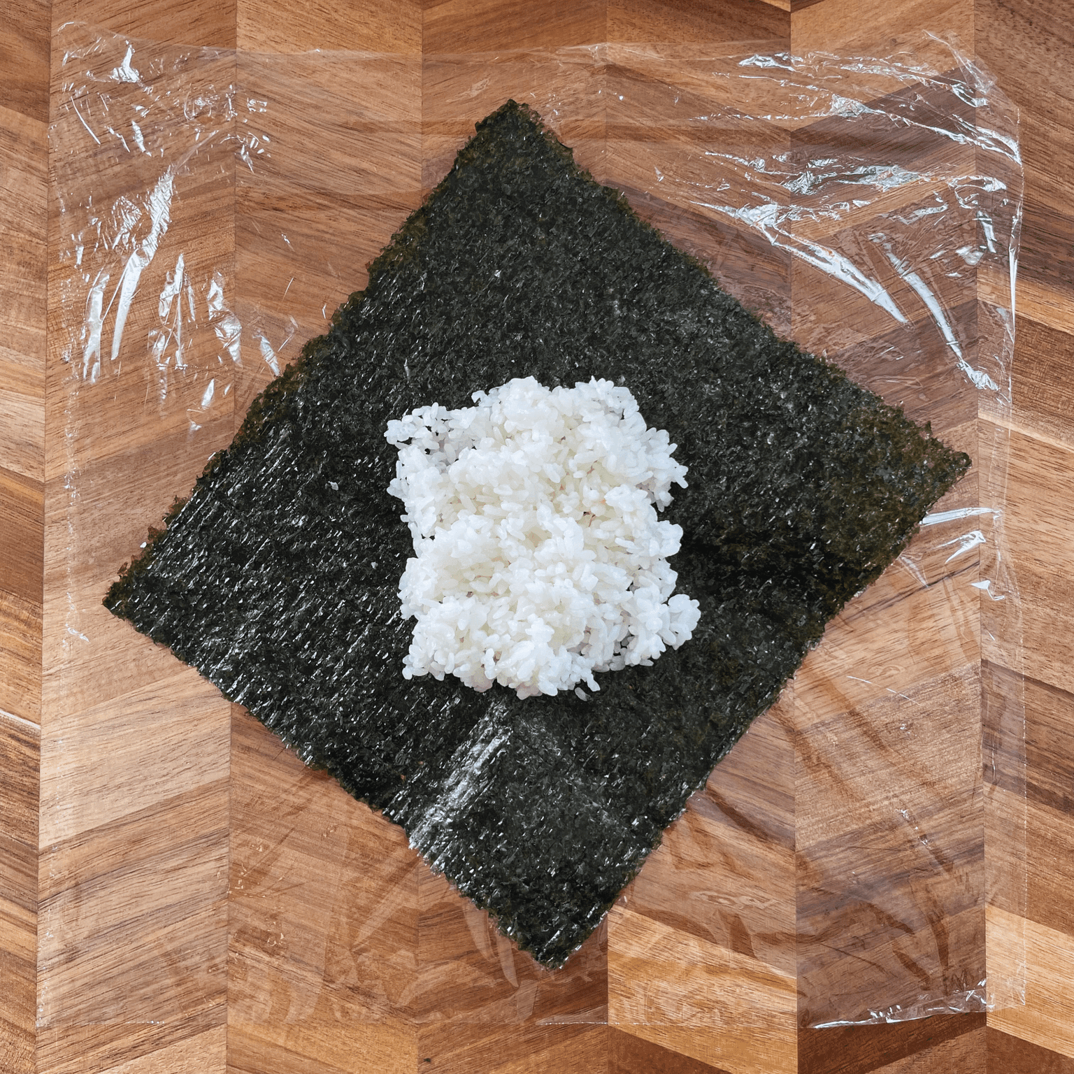 Rice placed on nori for onigirazu