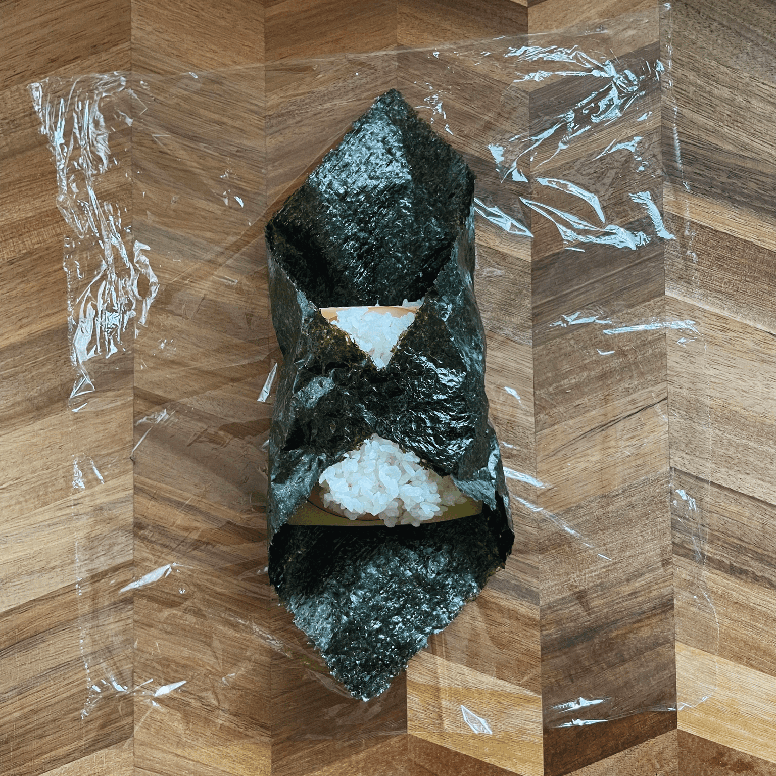 Ham, cheese and egg onigirazu folded before cutting