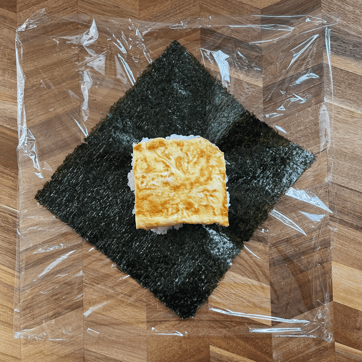 Egg filling placed on rice for onigirazu